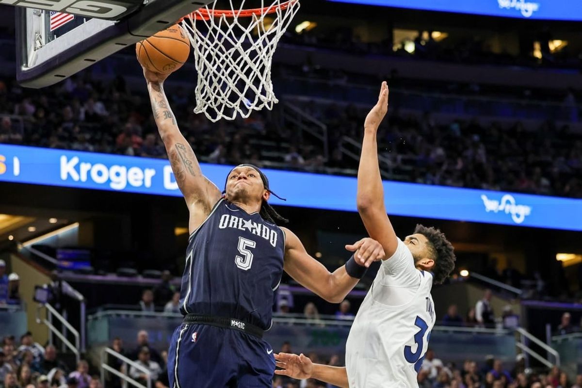 Jan 9, 2024; Orlando, Florida, USA; Orlando Magic forward Paolo Banchero (5) dunks against Minnesota Timberwolves center Karl-Anthony Towns (32) during the second half at KIA Center.