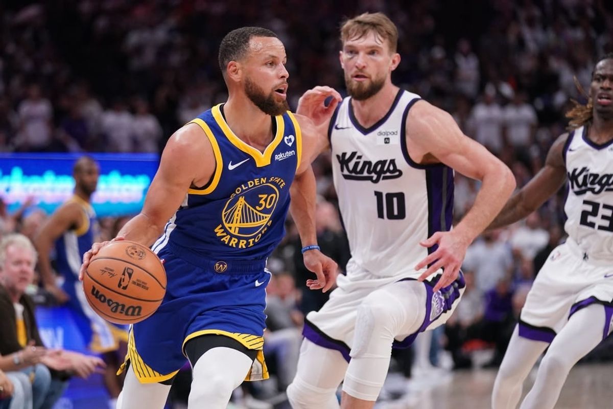 Apr 16, 2024; Sacramento, California, USA; Golden State Warriors guard Stephen Curry (30) dribbles the ball in front of Sacramento Kings forward Domantas Sabonis (10) in the fourth quarter during a play-in game of the 2024 NBA playoffs at the Golden 1 Center.