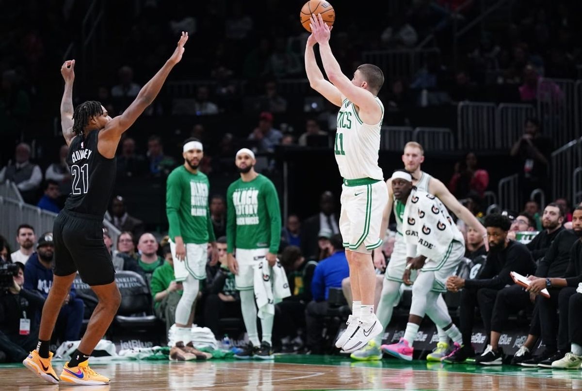 Feb 14, 2024; Boston, Massachusetts, USA; Boston Celtics guard Payton Pritchard (11) shoots for three points against Brooklyn Nets forward Noah Clowney (21) in the second half at TD Garden.