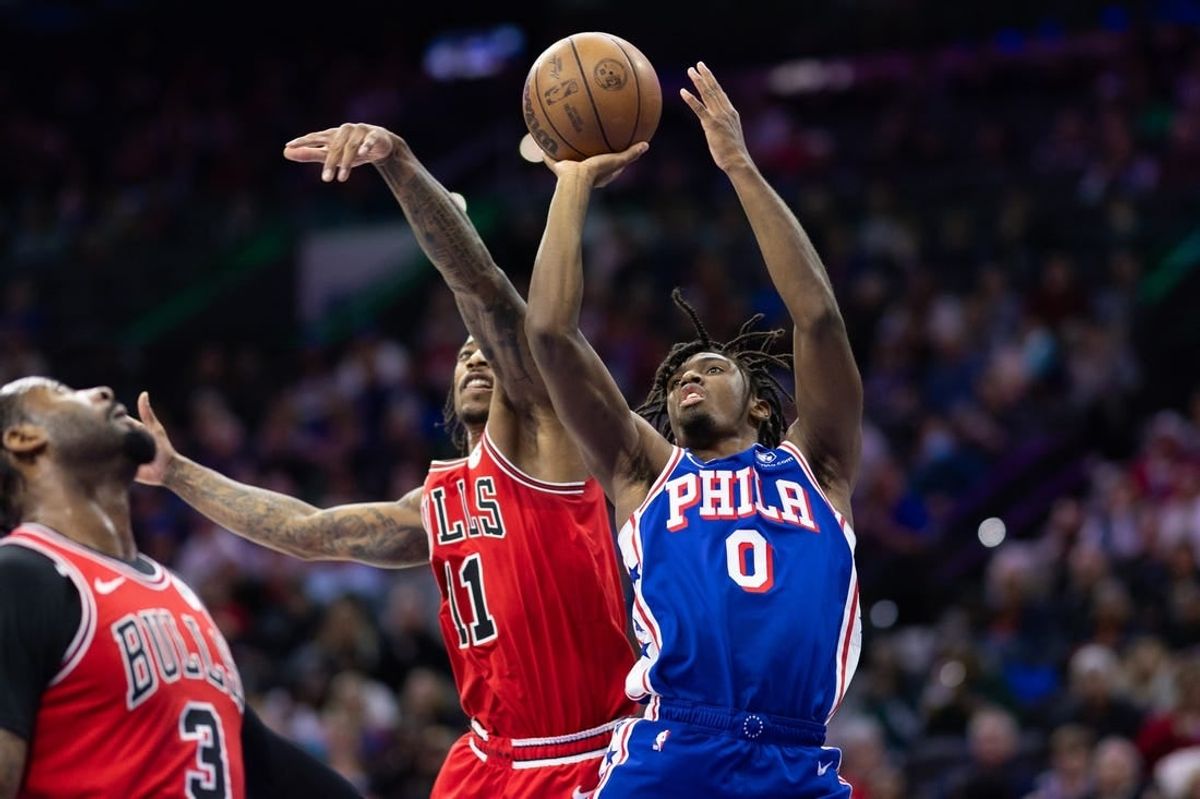 Dec 18, 2023; Philadelphia, Pennsylvania, USA; Philadelphia 76ers guard Tyrese Maxey (0) drives for a shot against Chicago Bulls forward DeMar DeRozan (11) during the second quarter at Wells Fargo Center.