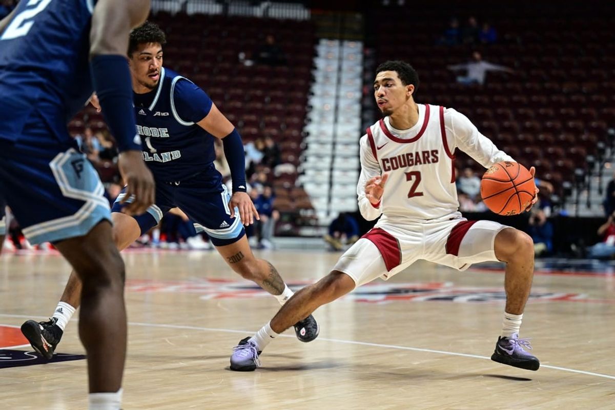 Nov 19, 2023; Uncasville, CT, USA; Washington State Cougars guard Myles Rice (2) dribbles the ball defended by Rhode Island Rams guard Luis Kortright (1) during the second half at Mohegan Sun Arena.