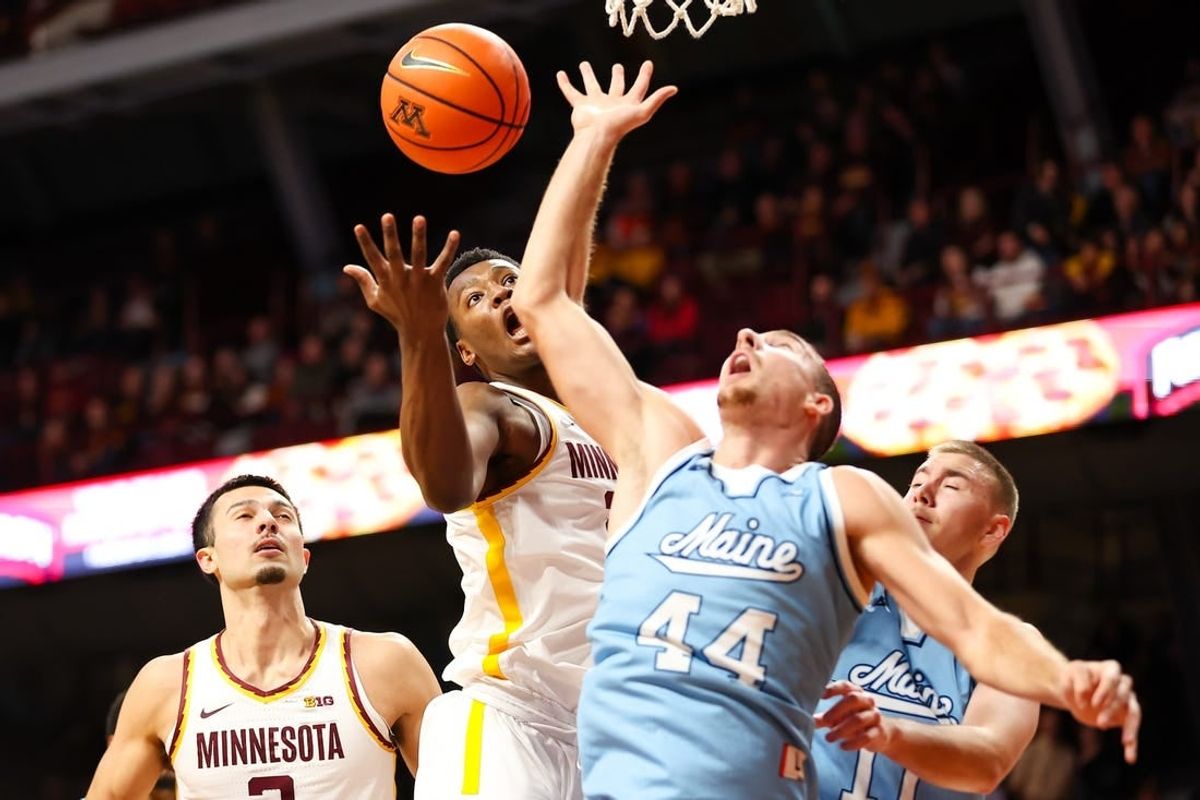 Dec 29, 2023; Minneapolis, Minnesota, USA; Minnesota Golden Gophers forward Pharrel Payne (21) and Maine Black Bears forward Peter Filipovity (44) jump for a rebound during the first half at Williams Arena.
