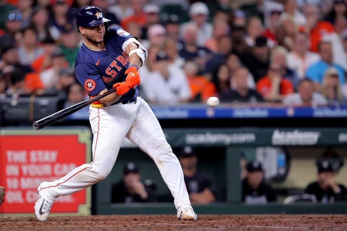 Mar 31, 2024; Houston, Texas, USA; Houston Astros designated hitter Yainer Diaz (21) hits an RBI single against the New York Yankees during the sixth inning at Minute Maid Park.