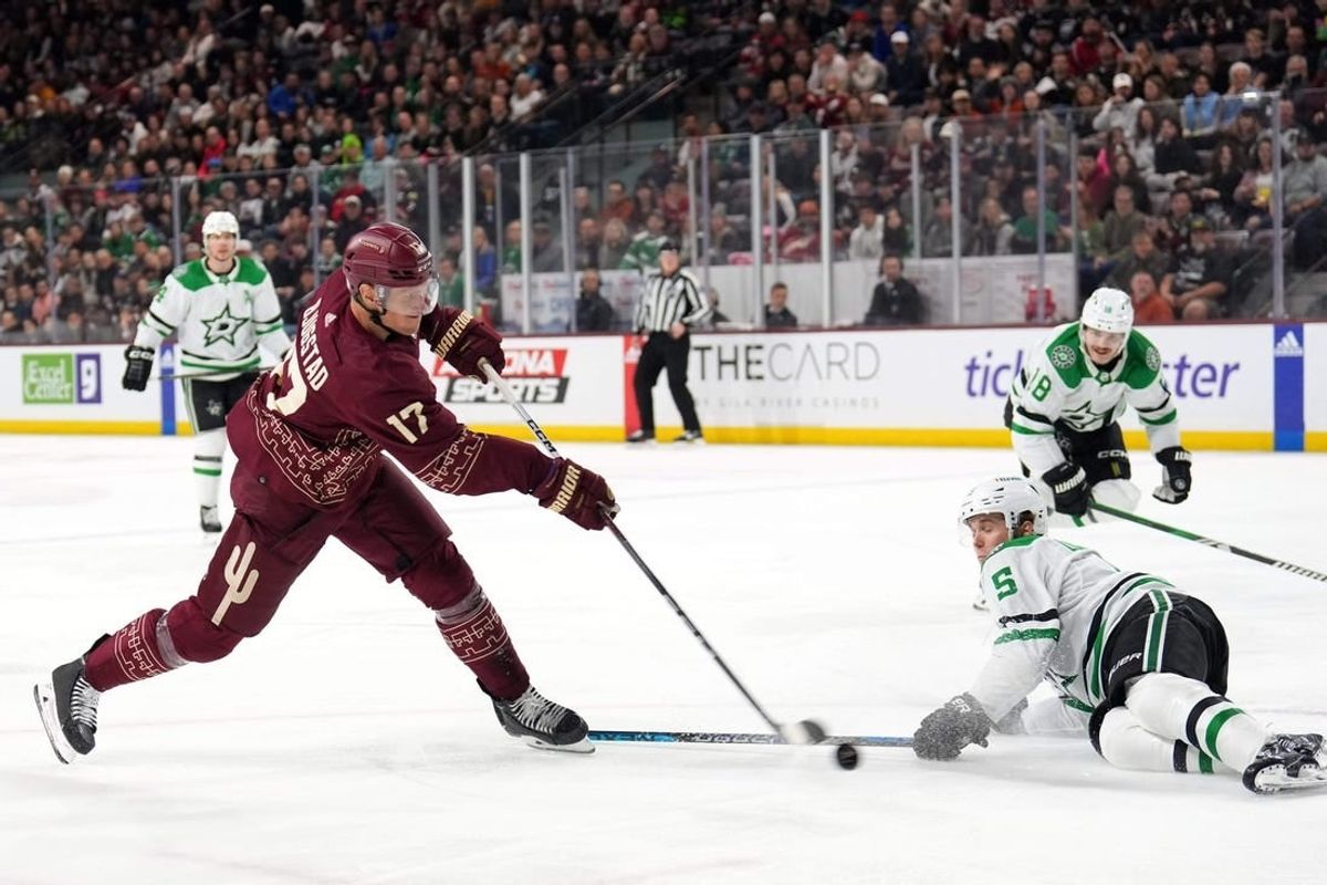 Mar 24, 2024; Tempe, Arizona, USA; Arizona Coyotes center Nick Bjugstad (17) shoots the puck by Dallas Stars defenseman Nils Lundkvist (5) during the second period at Mullett Arena.