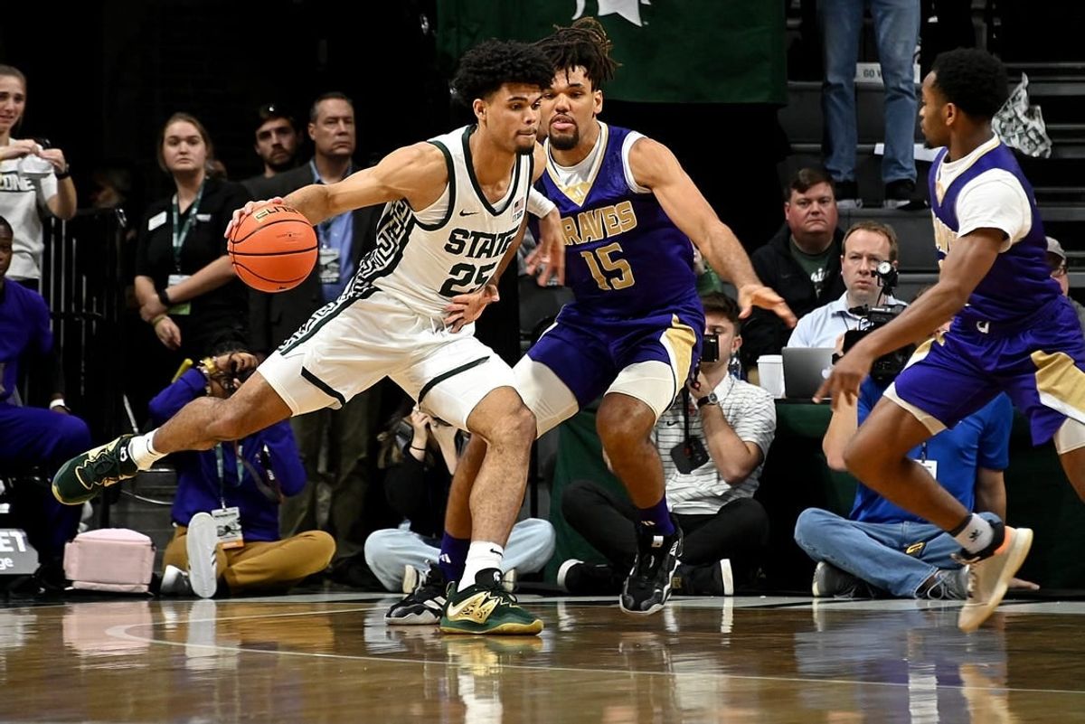 Nov 19, 2023; East Lansing, Michigan, USA;  Michigan State Spartans forward Malik Hall (25) drives past Alcorn State Braves forward Djahi Binet (15) during the first half at Jack Breslin Student Events Center.