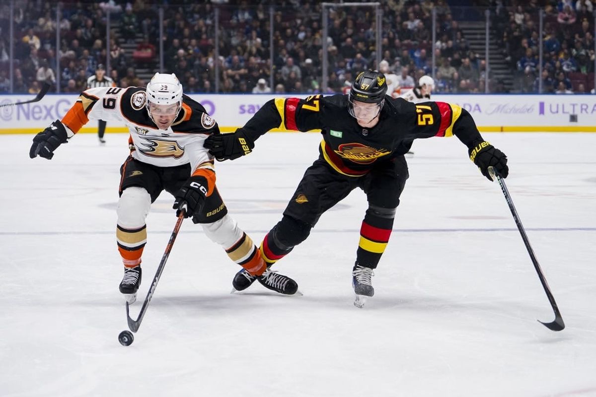 Nov 28, 2023; Vancouver, British Columbia, CAN; Vancouver Canucks defenseman Tyler Myers (57) battles with Anaheim Ducks forward Sam Carrick (39) in the first period at Rogers Arena.
