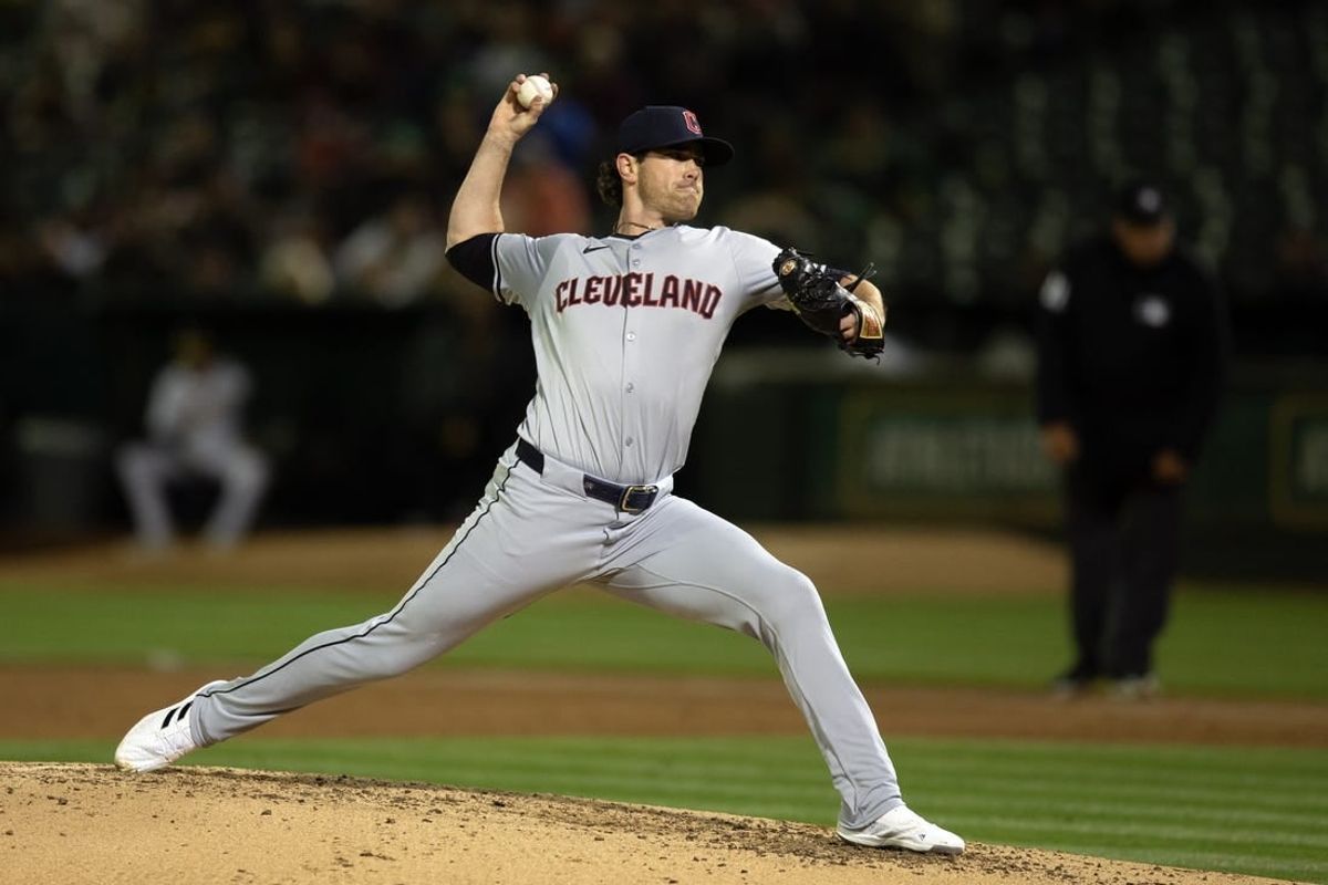 Mar 28, 2024; Oakland, California, USA; Cleveland Guardians starting pitcher Shane Bieber (57) delivers a pitch against the Oakland Athletics during the third inning at Oakland-Alameda County Coliseum.
