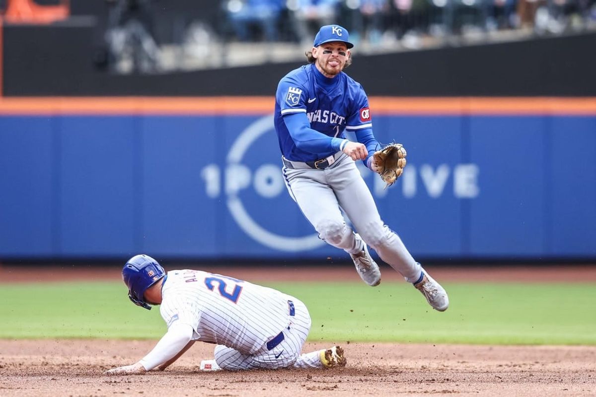 Apr 13, 2024; New York City, New York, USA;  Kansas City Royals shortstop Bobby Witt Jr. (7) leaps over New York Mets first baseman Pete Alonso (20) after throwing to first base attempting to complete a double play in the first inning at Citi Field.