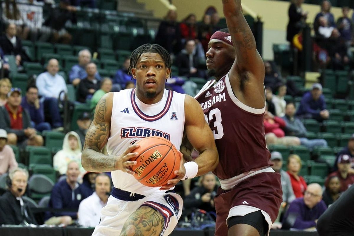 Nov 24, 2023; Kissimmee, FL, USA;Florida Atlantic Owls guard Alijah Martin (15) drives to the hoop guarded by Texas A&M Aggies guard Tyrece Radford (23) in the first half  during the ESPN Events Invitational Semifinals at State Farm Field House.