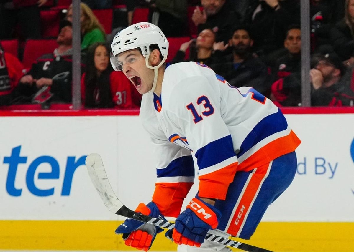 Nov 30, 2023; Raleigh, North Carolina, USA; New York Islanders center Mathew Barzal (13) celebrates his overtime winning goal against the Carolina Hurricanes at PNC Arena.