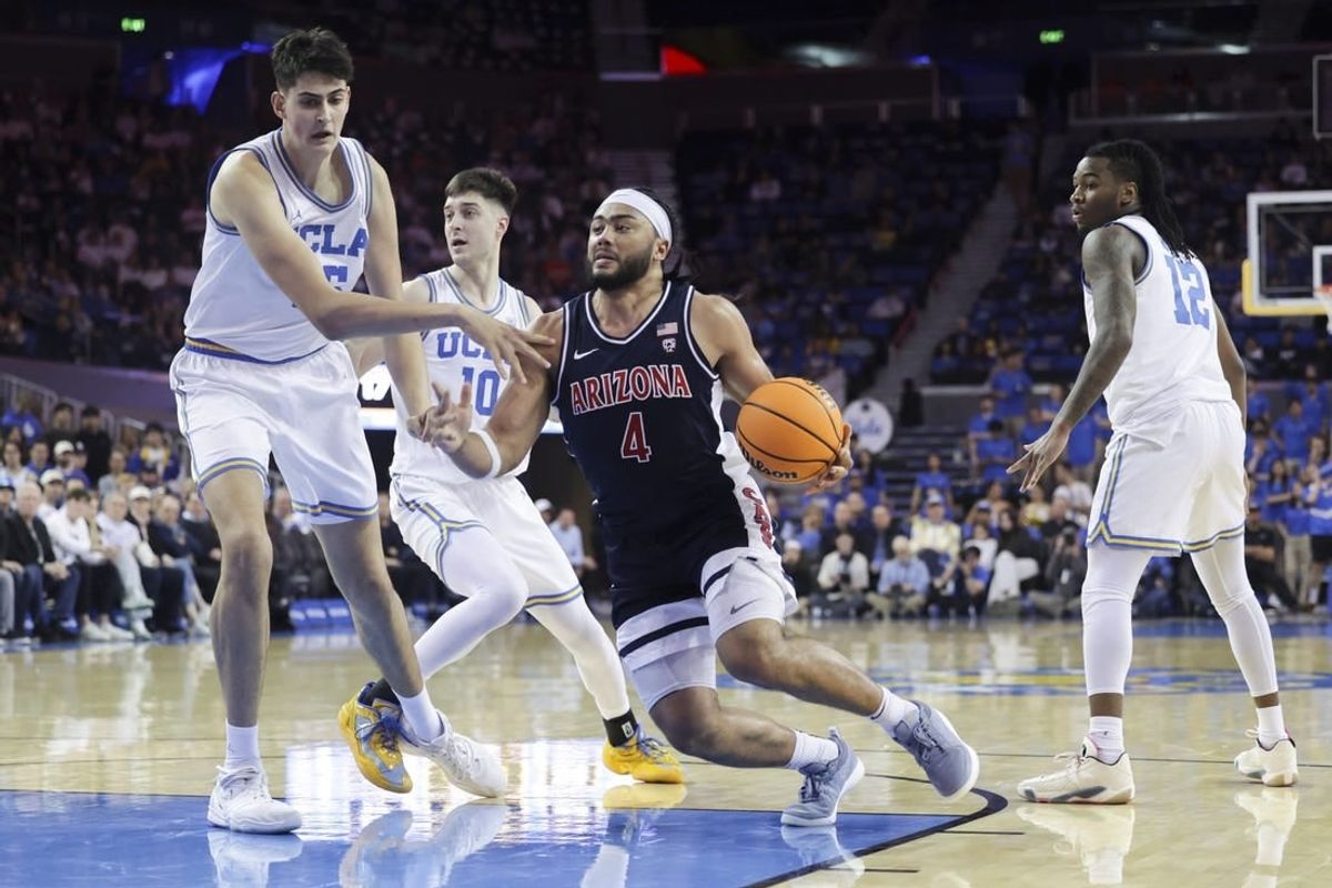 Mar 7, 2024; Los Angeles, California, USA; Arizona Wildcats guard Kylan Boswell (4) drives the ball against UCLA defenders during the first half at Pauley Pavilion presented by Wescom.