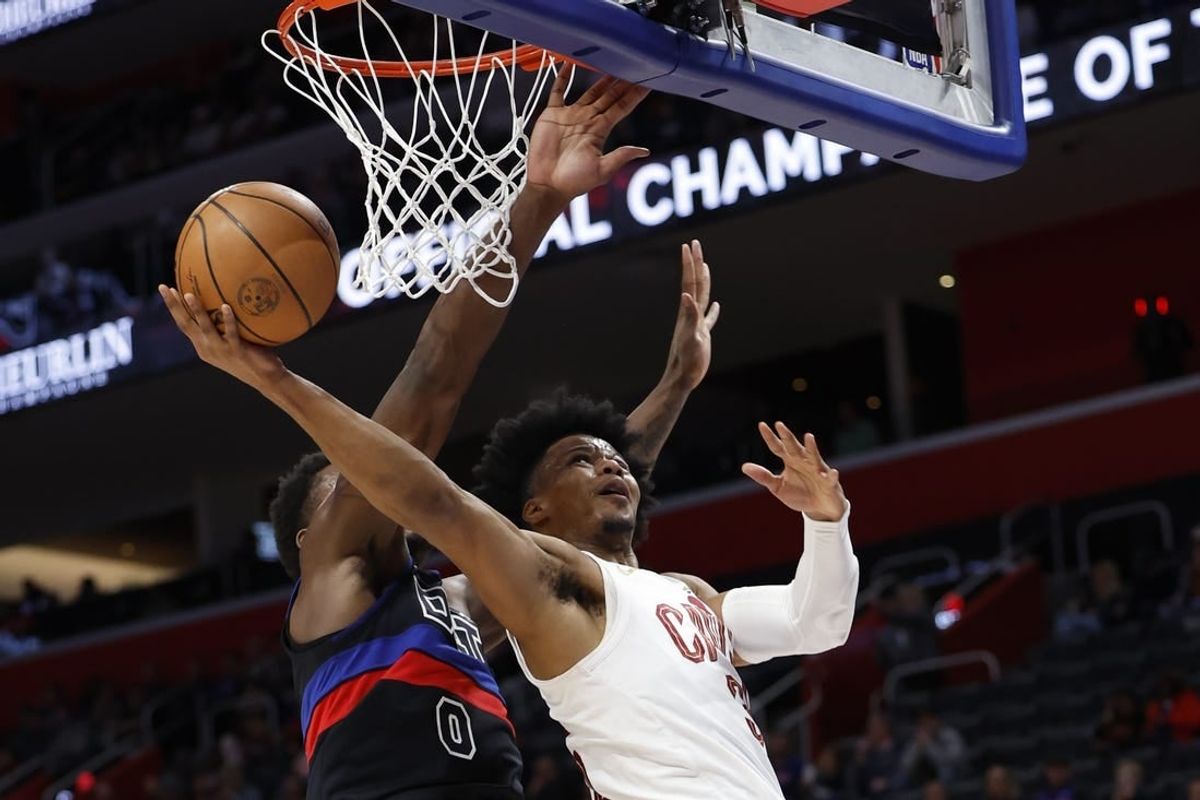 Mar 1, 2024; Detroit, Michigan, USA;  Cleveland Cavaliers forward Isaac Okoro (35) shoots on Detroit Pistons center Jalen Duren (0) in the first half at Little Caesars Arena.