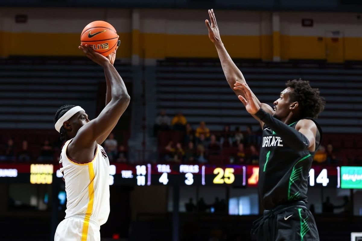 Nov 18, 2023; Minneapolis, Minnesota, USA; Minnesota Golden Gophers forward Isaiah Ihnen (5) shoots while USC Upstate Spartans guard Nick Alves (1) defends during the first half at Williams Arena.