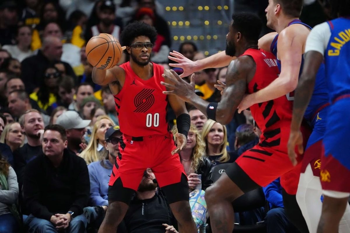 Feb 2, 2024; Denver, Colorado, USA; Portland Trail Blazers guard Scoot Henderson (00) passes the ball in the first half against the Denver Nuggets at Ball Arena.