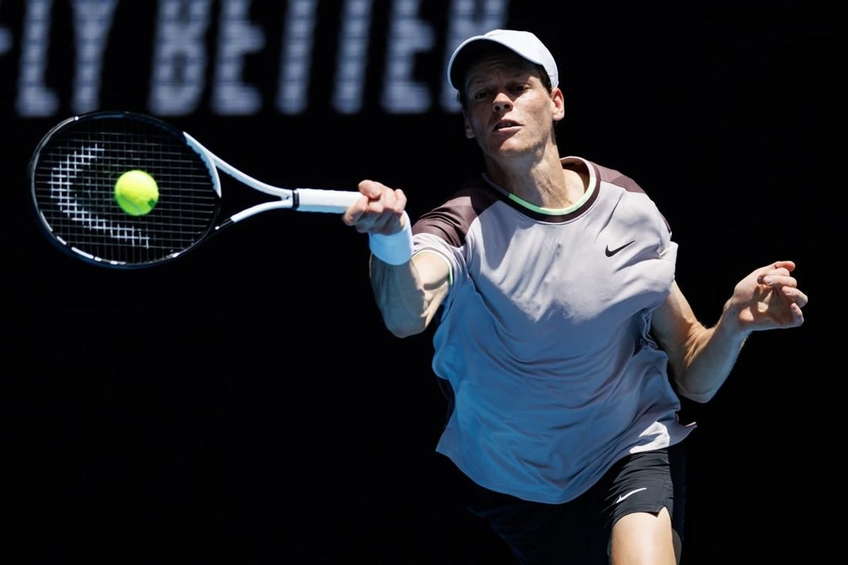 Jan 14, 2024; Melbourne, Victoria, Australia;   Jannik Sinner of Italy hits a shot against Botic Van De Zandschulp of the Netherlands in the first round of the men s singles.