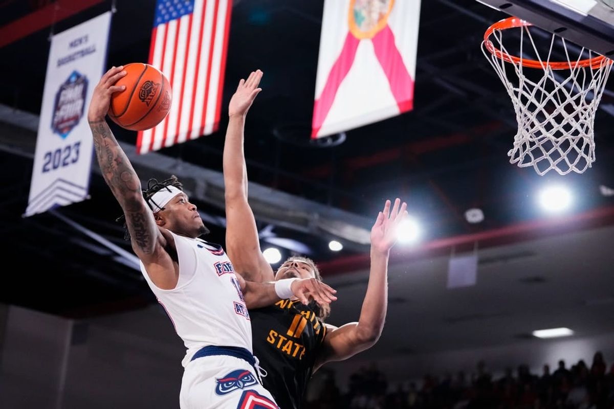 Jan 18, 2024; Boca Raton, Florida, USA; Florida Atlantic Owls guard Alijah Martin (15) goes up for a shot against Wichita State Shockers forward Kenny Pohto (11) during the second half at Eleanor R. Baldwin Arena.