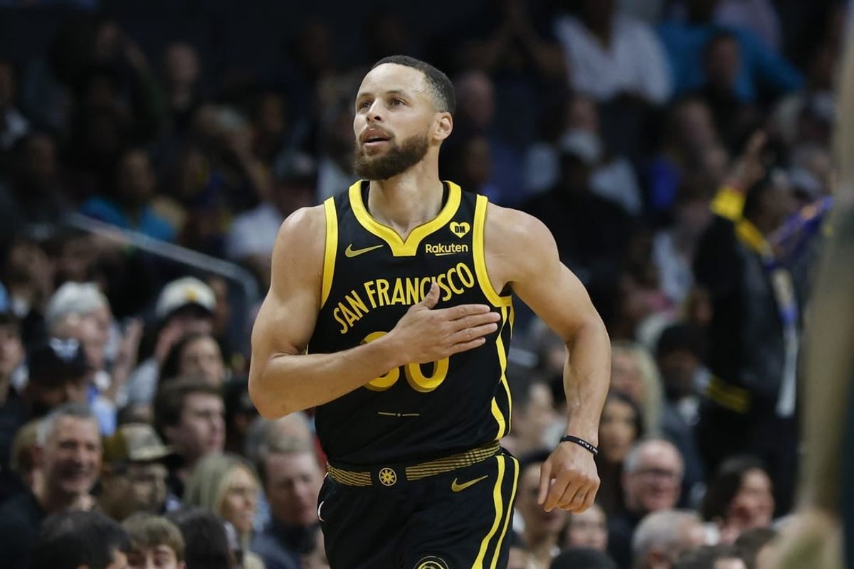 Mar 29, 2024; Charlotte, North Carolina, USA; Golden State Warriors guard Stephen Curry (30) pats his chest after making a three-point basket against the Charlotte Hornets during the first quarter at Spectrum Center.