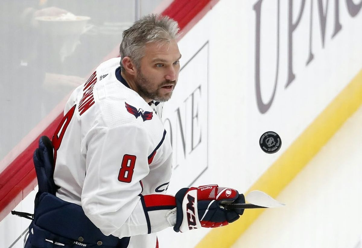 Jan 2, 2024; Pittsburgh, Pennsylvania, USA;  Washington Capitals left wing Alex Ovechkin (8) juggles the puck to warm up before the game against the Pittsburgh Penguins at PPG Paints Arena.