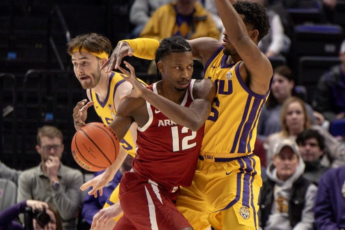 Feb 3, 2024; Baton Rouge, Louisiana, USA;  Arkansas Razorbacks guard Tramon Mark (12) dribbles into LSU Tigers guard Jordan Wright (6) to get to the basket during the first half at Pete Maravich Assembly Center.