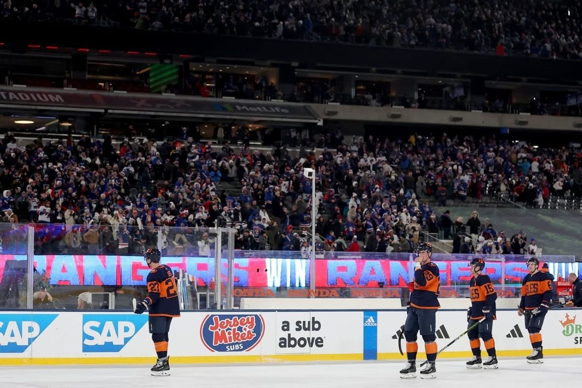 Feb 18, 2024; East Rutherford, New Jersey, USA; New York Islanders left wing Anders Lee (27) and center Brock Nelson (29) and right wing Cal Clutterbuck (15) and defenseman Ryan Pulock (6) skate off the ice after losing to the New York Rangers in a Stadium Series ice hockey game at MetLife Stadium.