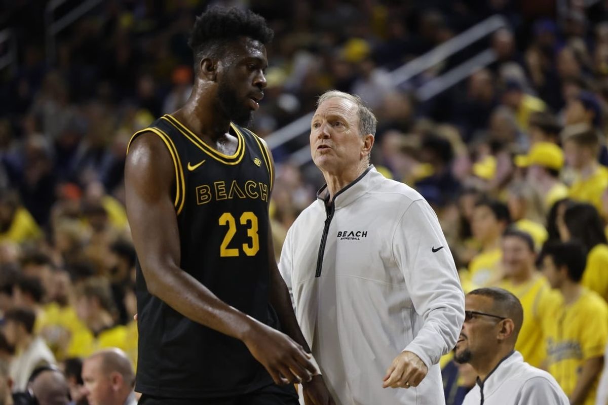 Nov 17, 2023; Ann Arbor, Michigan, USA;  Long Beach State 49ers head coach Dan Monson talks to 49ers forward Lassina Traore (23) in the first half at Crisler Center.