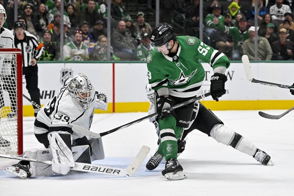 Jan 16, 2024; Dallas, Texas, USA; Los Angeles Kings goaltender Cam Talbot (39) stops a backhand shot by Dallas Stars center Wyatt Johnston (53) during the second period at the American Airlines Center.