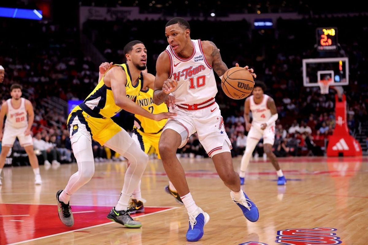 Dec 26, 2023; Houston, Texas, USA; Houston Rockets forward Jabari Smith Jr. (10) handles the ball against Indiana Pacers guard Tyrese Haliburton (0) during the first quarter at Toyota Center.