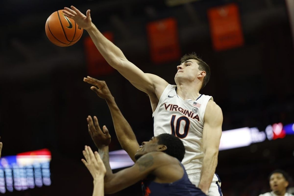 Dec 27, 2023; Charlottesville, Virginia, USA; Virginia Cavaliers guard Taine Murray (10) blocks the shot of Morgan State Bears guard Amahrie Simpkins (11) in the first half at John Paul Jones Arena.