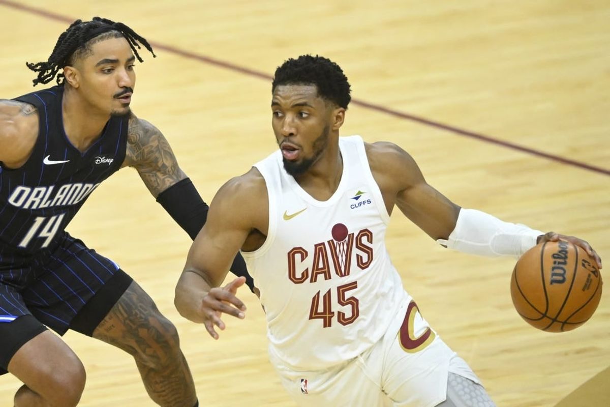Apr 20, 2024; Cleveland, Ohio, USA; Orlando Magic guard Gary Harris (14) defends Cleveland Cavaliers guard Donovan Mitchell (45) in the fourth quarter during game one of the first round for the 2024 NBA playoffs at Rocket Mortgage FieldHouse.