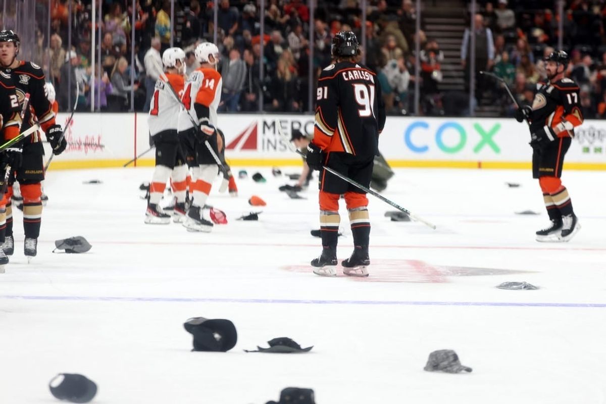 Nov 10, 2023; Anaheim, California, USA; Fans throw hats as Anaheim Ducks center Leo Carlsson (91) records a hat trick during the third period against the Philadelphia Flyers at Honda Center.