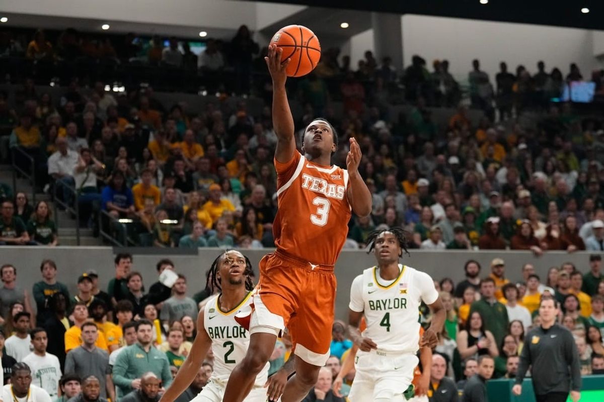 Mar 4, 2024; Waco, Texas, USA;  Texas Longhorns guard Max Abmas (3) scores a layup past Baylor Bears guard Jayden Nunn (2) during the first half at Paul and Alejandra Foster Pavilion.