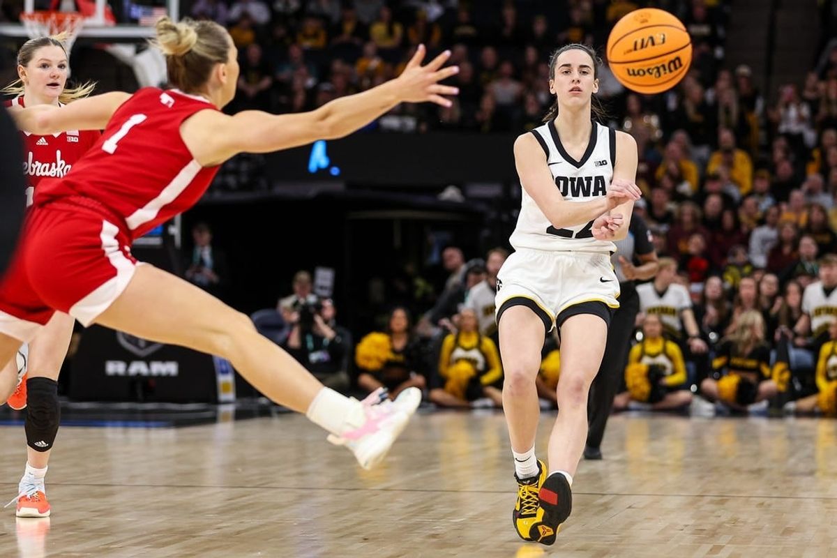Mar 10, 2024; Minneapolis, MN, USA; Iowa Hawkeyes guard Caitlin Clark (22) passes as Nebraska Cornhuskers guard Jaz Shelley (1) defends during the first half at Target Center.