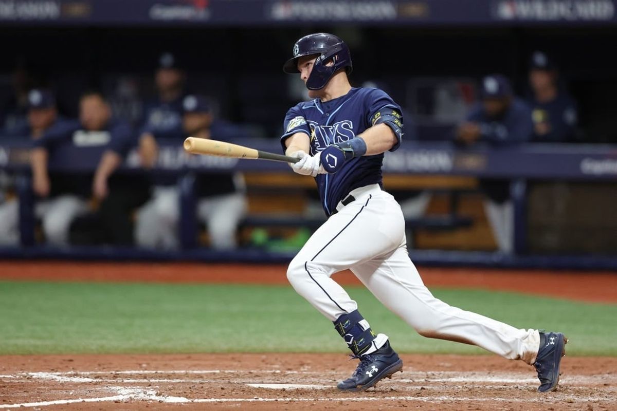 Oct 4, 2023; St. Petersburg, Florida, USA; Tampa Bay Rays second baseman Curtis Mead (25) hits an RBI single against the Texas Rangers in the seventh inning during game two of the Wildcard series for the 2023 MLB playoffs at Tropicana Field.