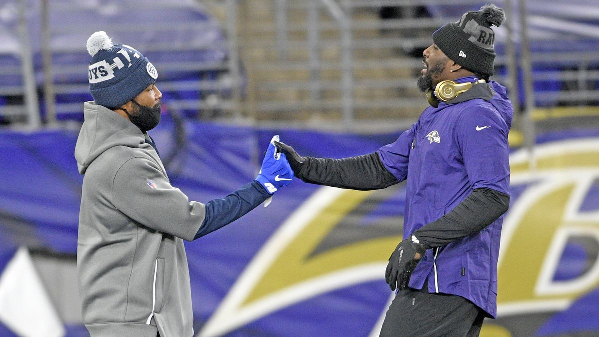 Maskless and with COVID-19, Dez Bryant (r.)  greeted former teammates before Tuesday’s game with the Cowboys.
