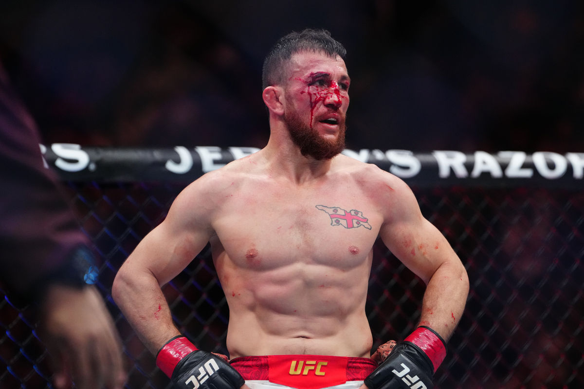 Dec 6, 2025; Las Vegas, Nevada, UNITED STATES; Merab Dvalishvili (red gloves) during the fight against Petr Yan (blue gloves) during UFC 323 at T-Mobile Arena. Mandatory Credit: Stephen R. Sylvanie-Imagn Images
