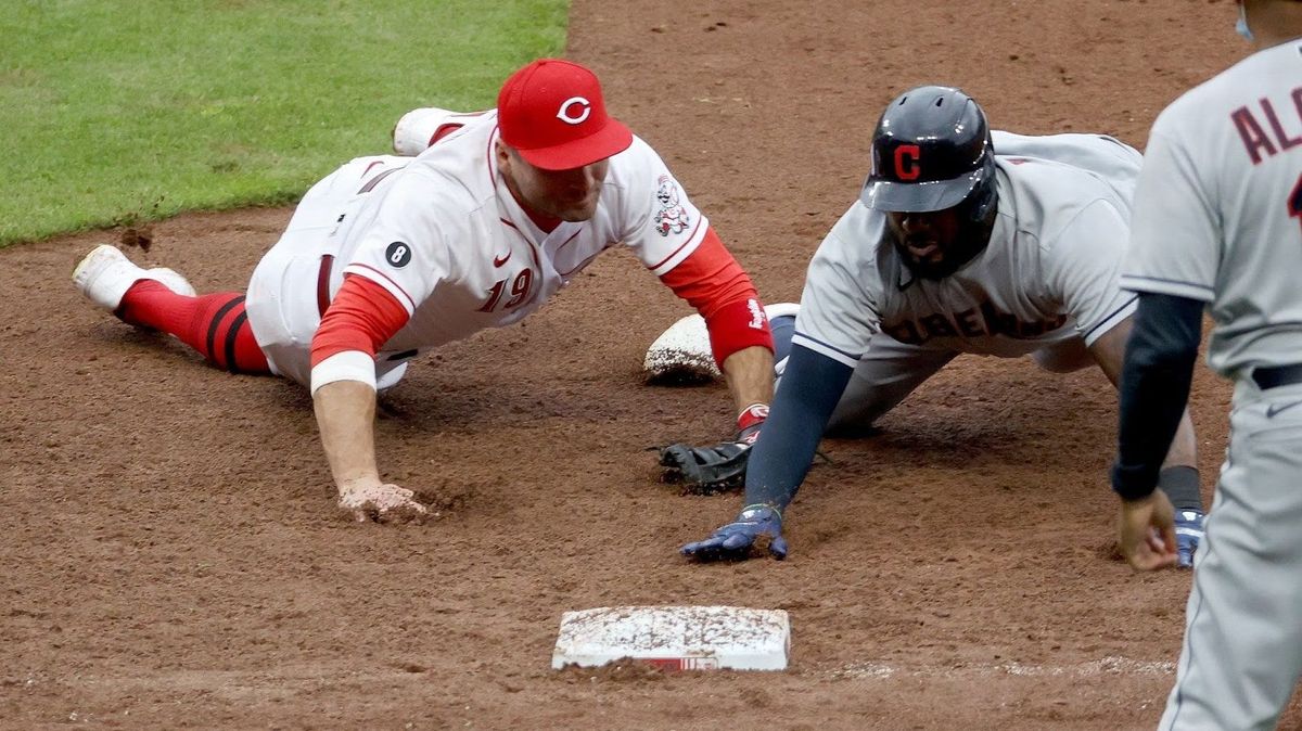 Joey Votto tags out Franmil Reyes at first base as part of a triple play in the eighth inning at Great American Ball Park.