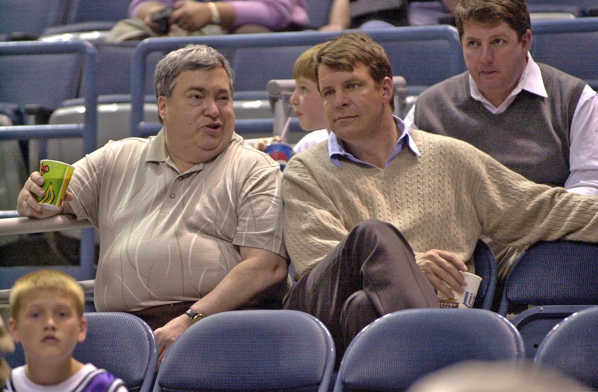 Former Bulls GM Jerry Krause sits in the stands with Tim Floyd, the man he tabbed to replace Phil Jackson as head coach of the Chicago Bulls.
