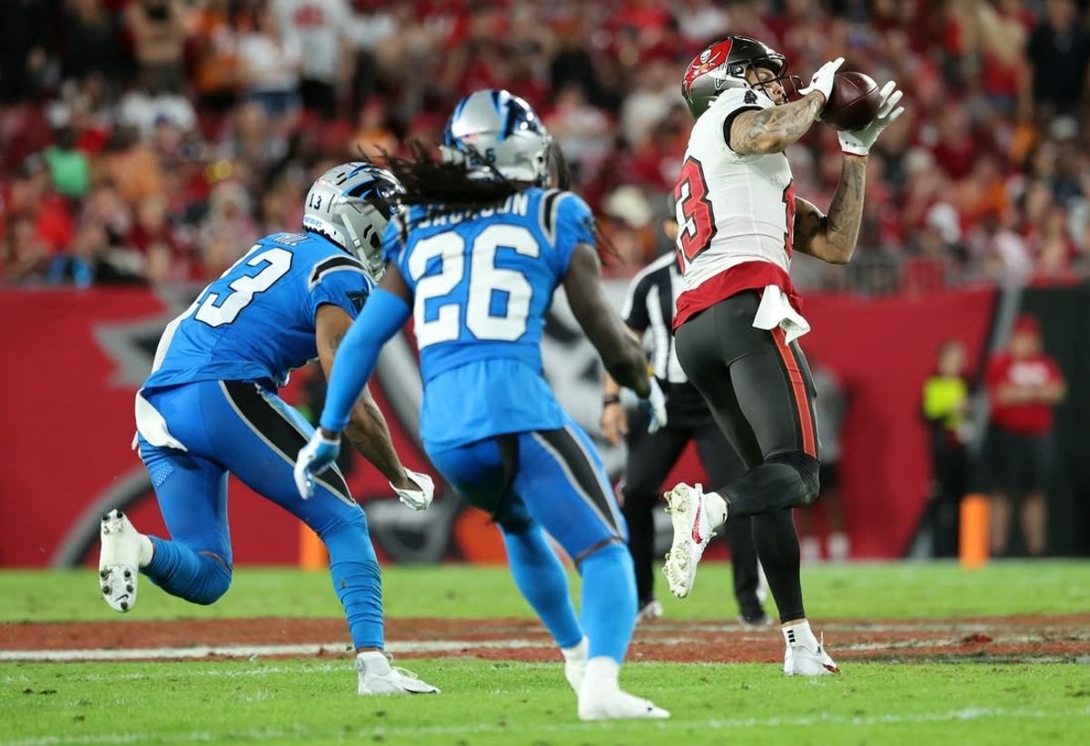 Dec 3, 2023; Tampa, Florida, USA; Tampa Bay Buccaneers wide receiver Mike Evans (13) catches the ball and runs it in for a touchdown  against the Carolina Panthers during the second half at Raymond James Stadium.