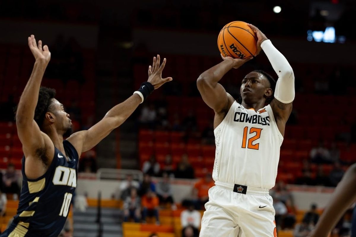 Dec 17, 2023; Stillwater, Okla, USA ; Oklahoma State Cowboys guard Javon Small (12) shoots over Oral Roberts Golden Eagles guard Issac McBride (10) in the first half of an NCAA basketball game at Gallagher Iba arena.