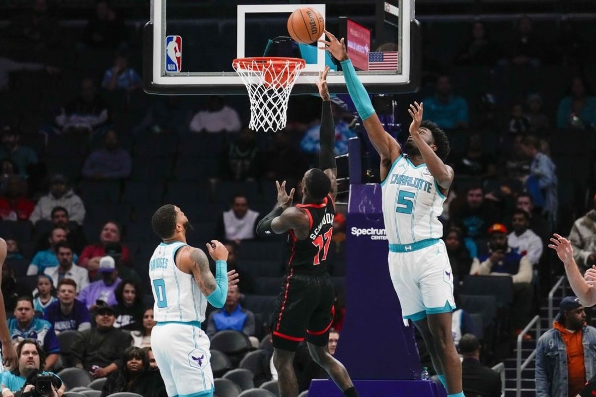 Dec 8, 2023; Charlotte, North Carolina, USA; Charlotte Hornets center Mark Williams (5) blocks a shot by Toronto Raptors guard Dennis Schroder (17)  during the first quarter at the Spectrum Center.