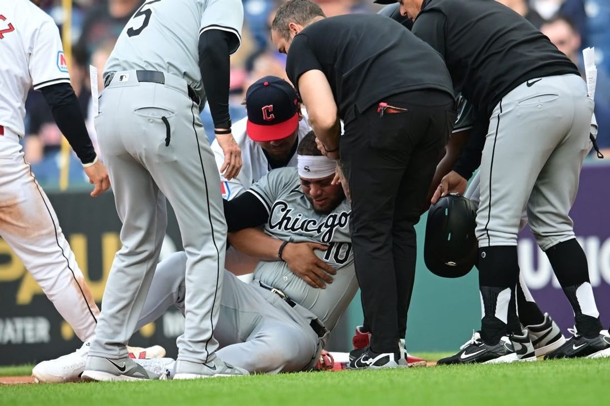 Apr 9, 2024; Cleveland, Ohio, USA; Chicago White Sox third baseman Yoan Moncada (10) is helped up after being injured during the second inning against the Cleveland Guardians at Progressive Field.