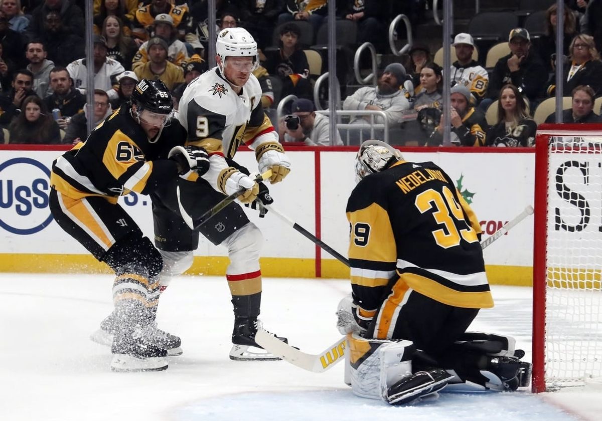 Nov 19, 2023; Pittsburgh, Pennsylvania, USA;  Pittsburgh Penguins goaltender Alex Nedeljkovic (39) makes a save against Vegas Golden Knights center Jack Eichel (9) as Pens defenseman Erik Karlsson (65) defends during the second period at PPG Paints Arena. Pittsburgh won 3-0.