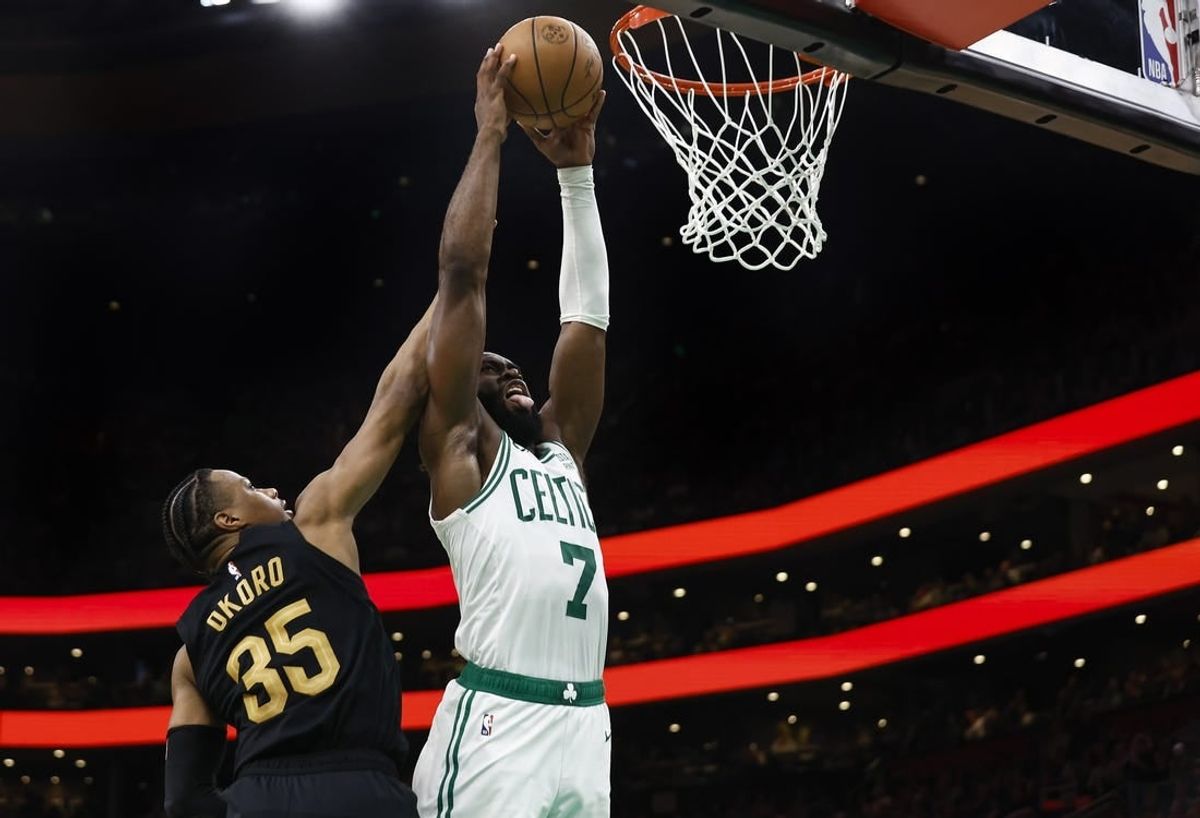 May 7, 2024; Boston, Massachusetts, USA; Boston Celtics guard Jaylen Brown (7) goes in for a dunk on Cleveland Cavaliers forward Isaac Okoro (35) during the third quarter of game one of the second round of the 2024 NBA playoffs at TD Garden.