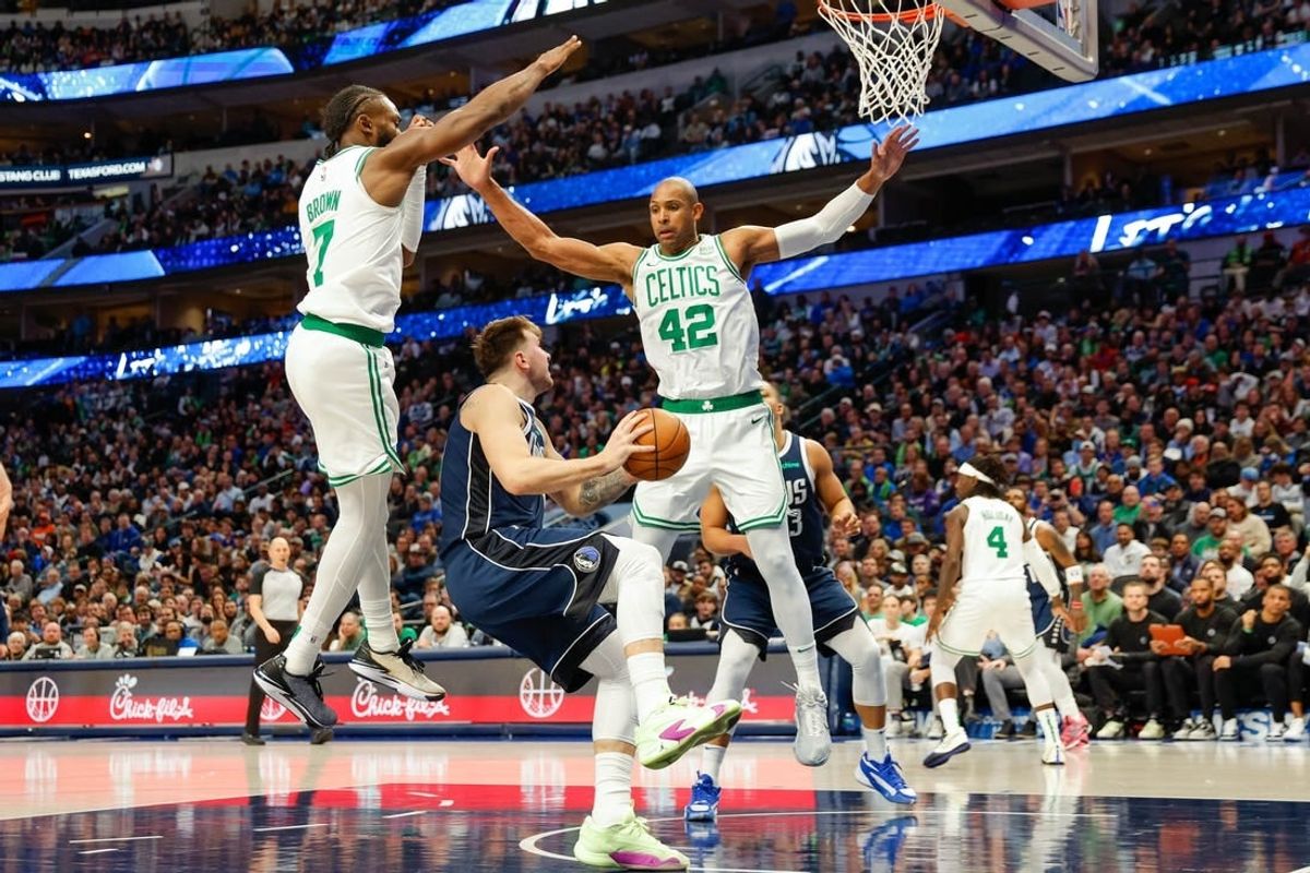 Jan 22, 2024; Dallas, Texas, USA; Dallas Mavericks guard Luka Doncic (77) looks to shoot with Boston Celtics center Al Horford (42) and guard Jaylen Brown (7) defending during the third quarter at American Airlines Center.
