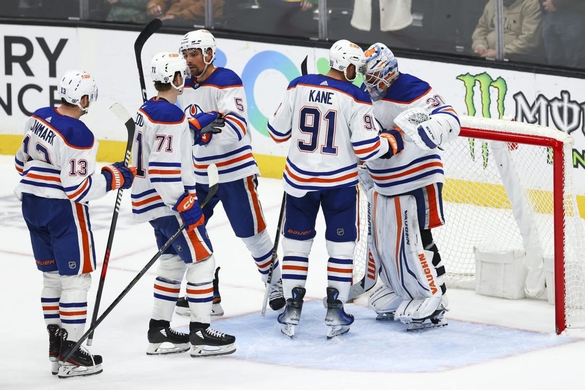 Feb 9, 2024; Anaheim, California, USA; Edmonton Oilers left wing Evander Kane (91) and goaltender Calvin Pickard (30) celebrate after the Edmonton Oilers defeat the Anaheim Ducks at Honda Center.