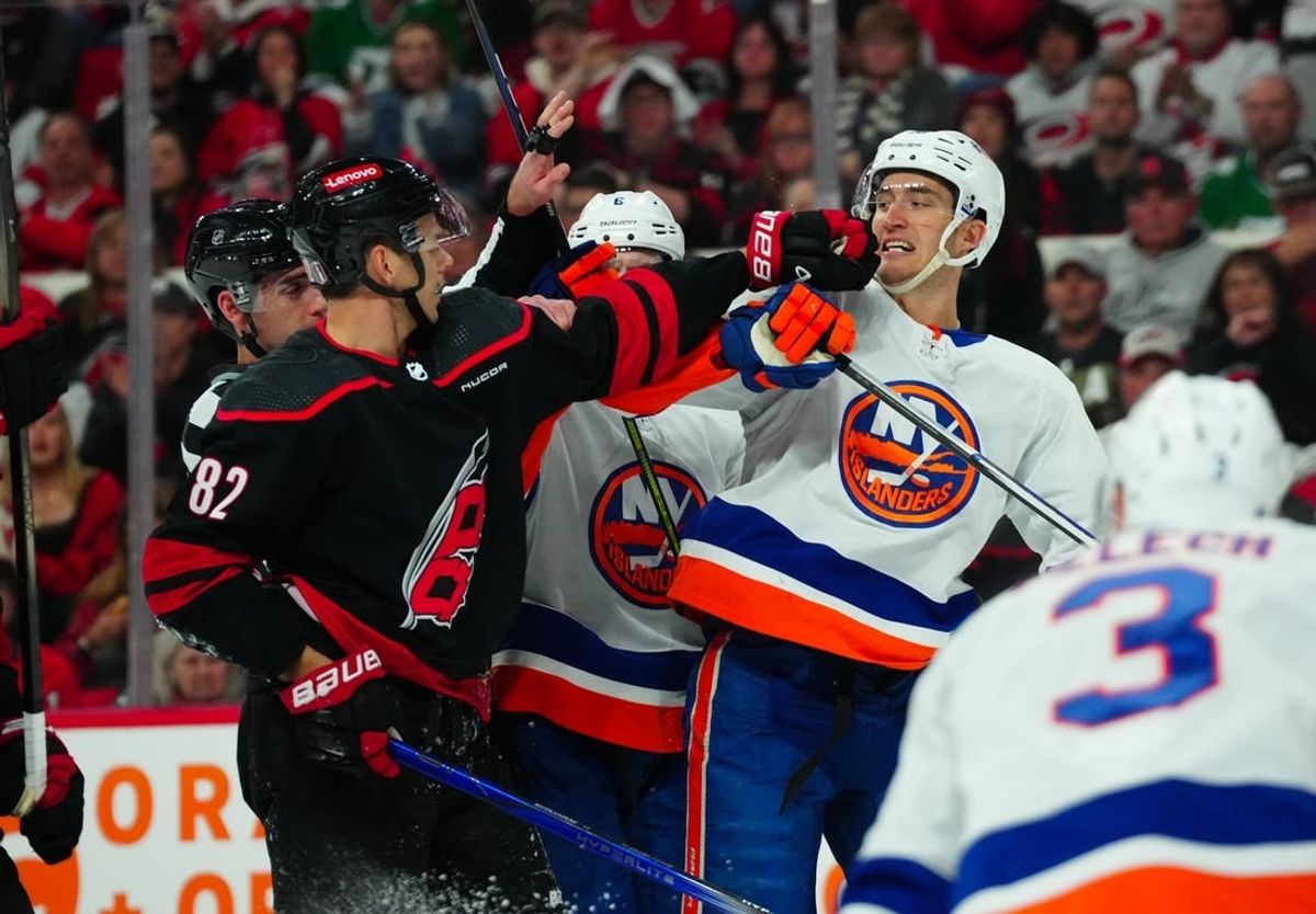 Apr 22, 2024; Raleigh, North Carolina, USA; New York Islanders center Brock Nelson (29) and Carolina Hurricanes center Jesperi Kotkaniemi (82) battle during the first period in game two of the first round of the 2024 Stanley Cup Playoffs at PNC Arena.