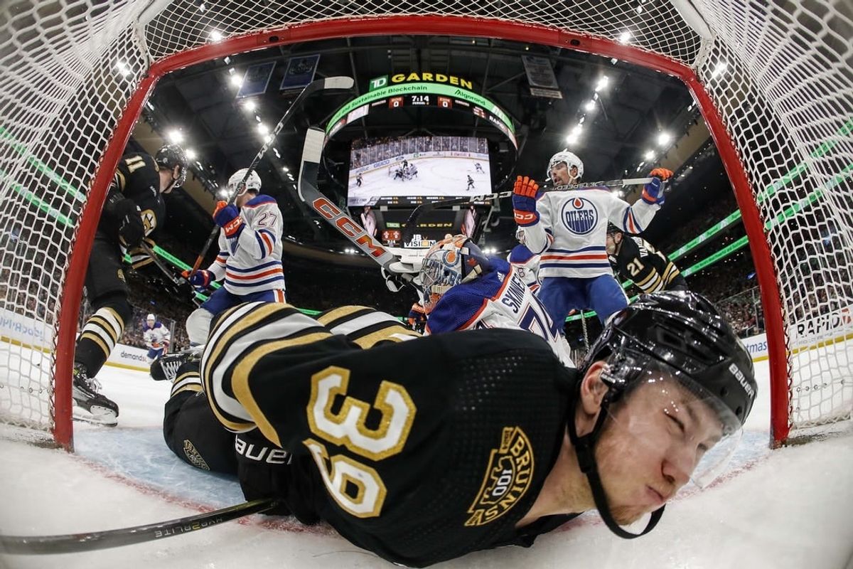 Mar 5, 2024; Boston, Massachusetts, USA; Boston Bruins center Morgan Geekie (39) is dumped into the Edmonton Oilers net during the second period at TD Garden.