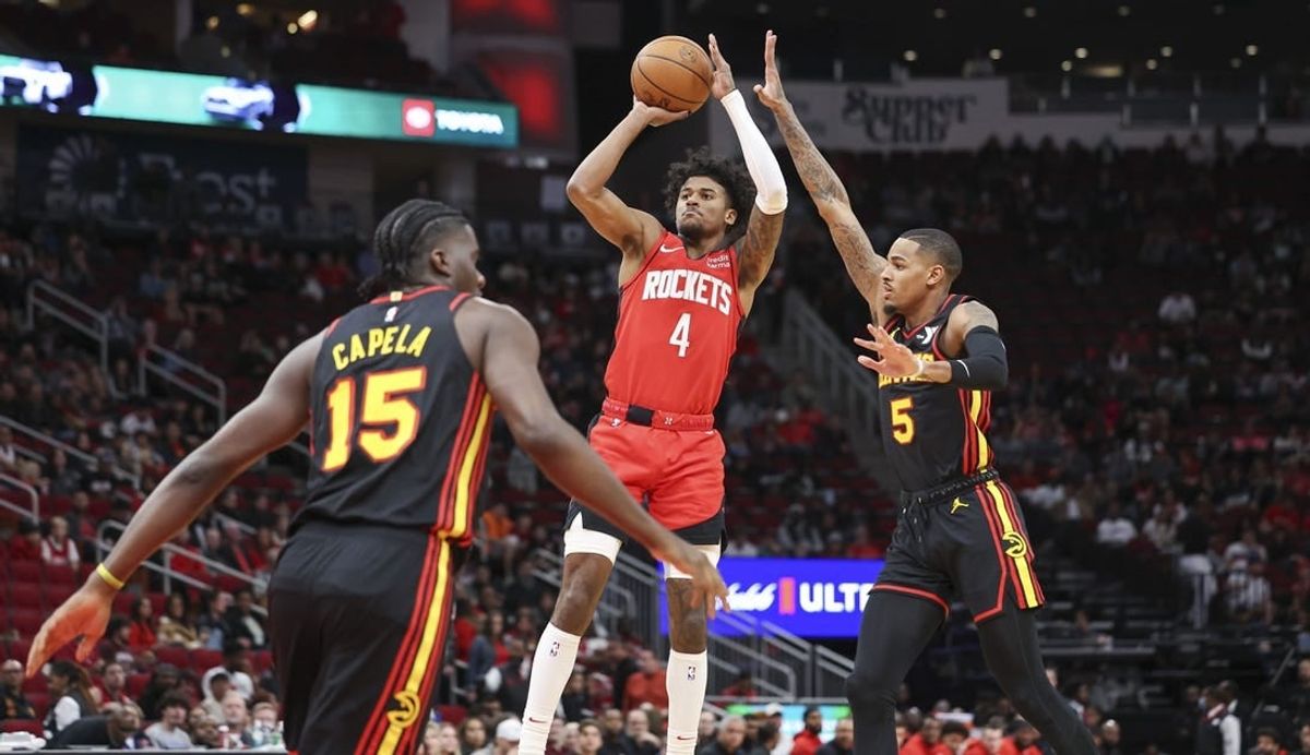 Dec 20, 2023; Houston, Texas, USA; Houston Rockets guard Jalen Green (4) shoots the ball as Atlanta Hawks guard Dejounte Murray (5) defends during the first quarter at Toyota Center.