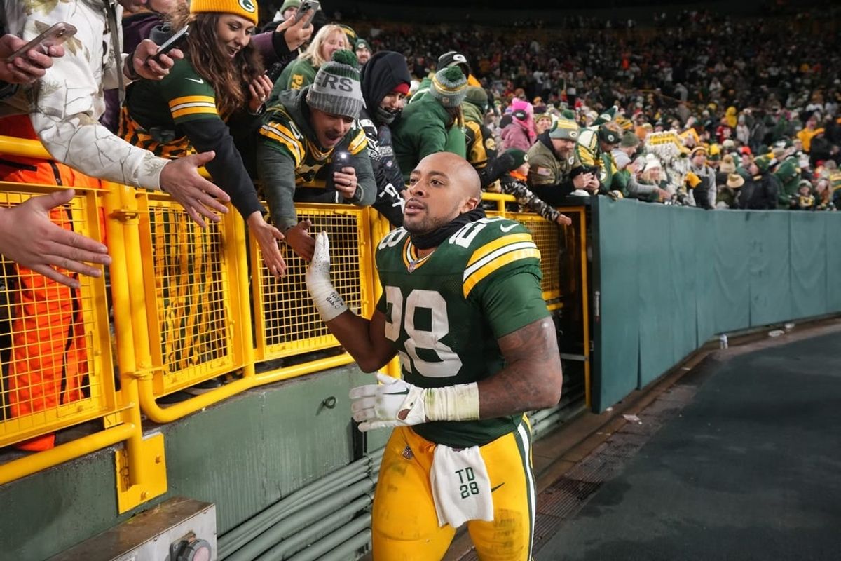 Dec 3, 2023; Green Bay, Wisconsin, USA; Green Bay Packers running back AJ Dillon (28) makes a victory lap after their game against the Kansas City Chiefs at Lambeau Field.