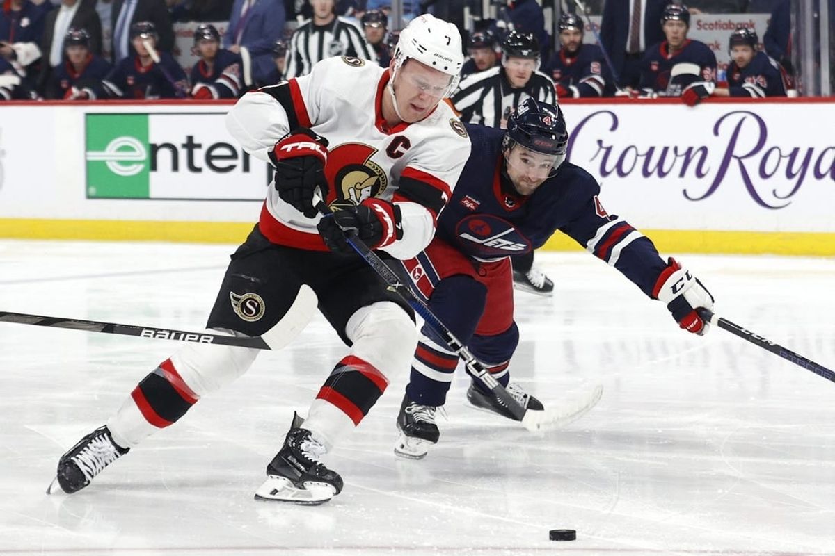 Mar 30, 2024; Winnipeg, Manitoba, CAN; Ottawa Senators left wing Brady Tkachuk (7) is chased down by Winnipeg Jets defenseman Neal Pionk (4) in the first period at Canada Life Centre.